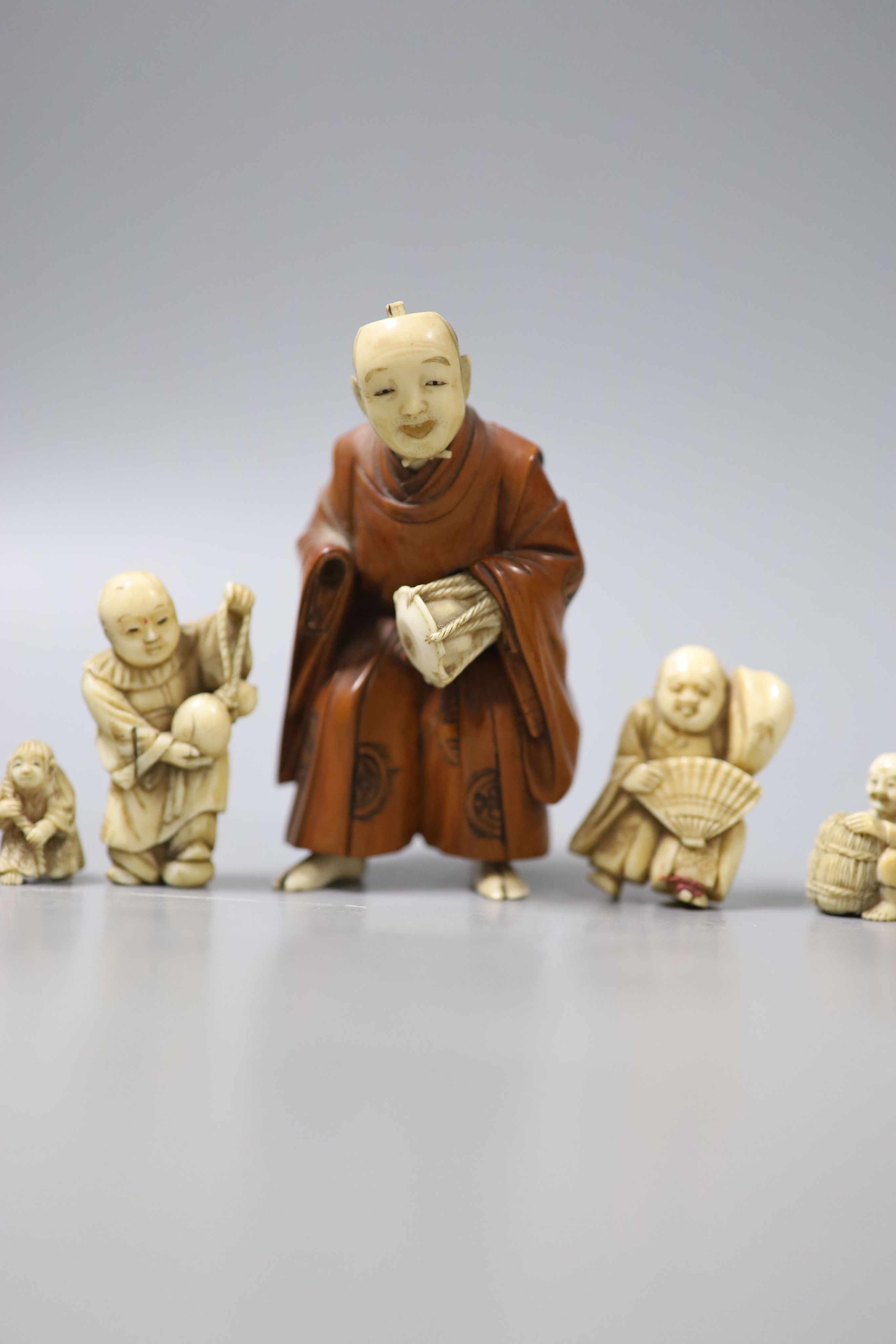 Three Japanese ivory netsuke, a similar okimono and a boxwood and ivory okimono, 9cm (losses)